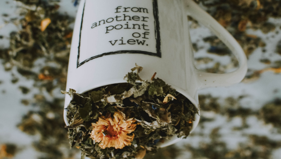 Naturopathy. A cup filled with dried flowers and leaves representing Naturopathy. The cup features the inscription 'from another point of view' written in reverse.