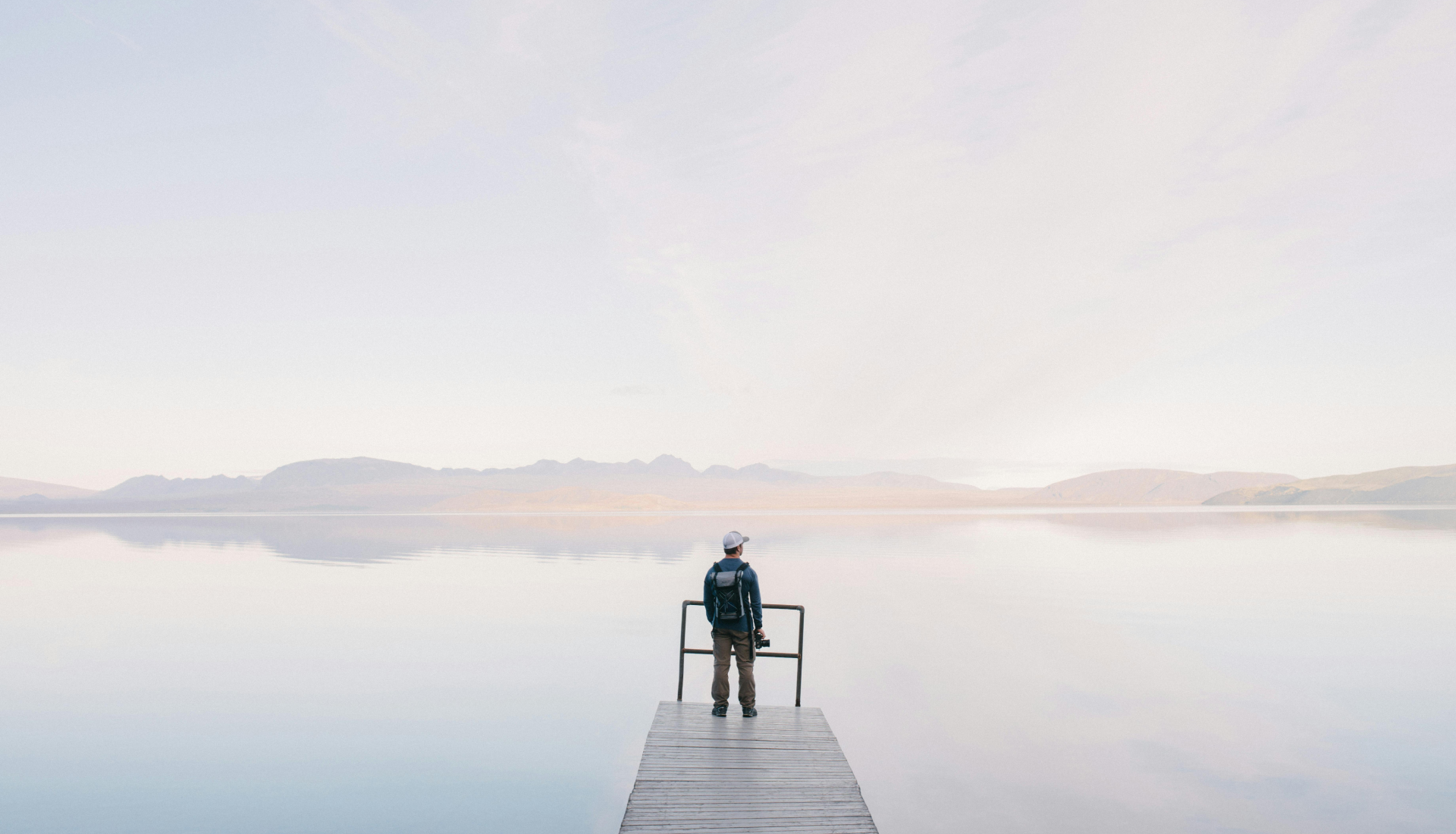 A photographer observes a lake with clear waters